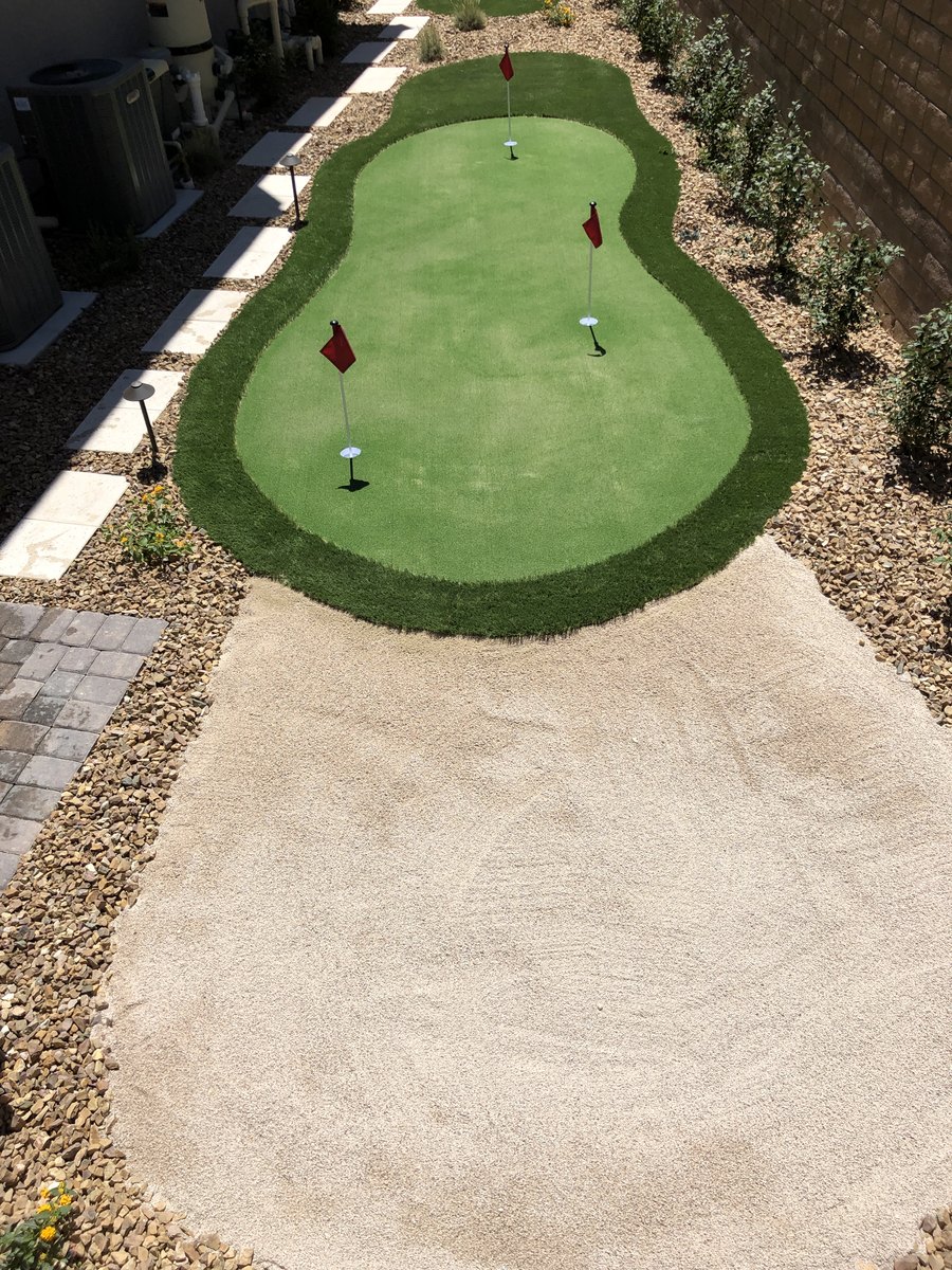 Backyard putting green with desert rock