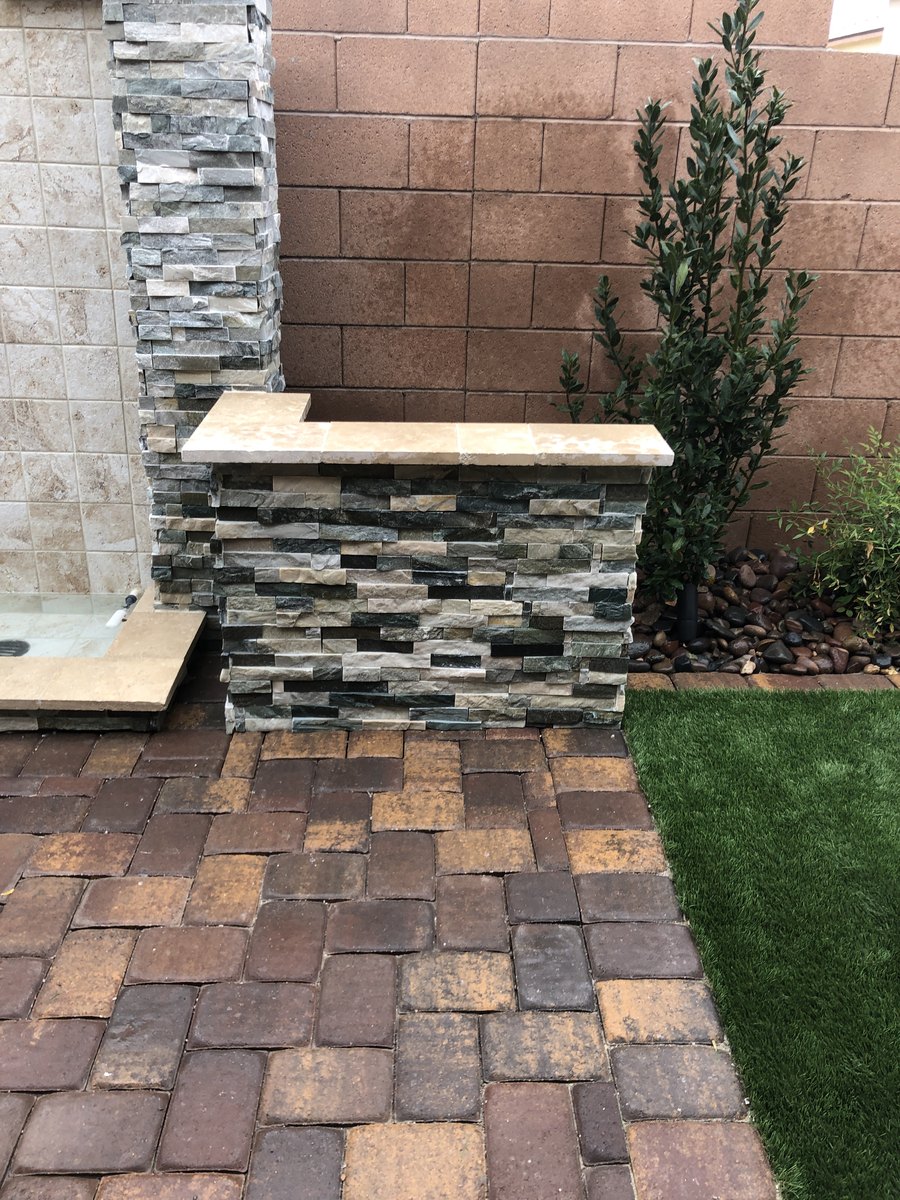 Paver patio and stone feature wall