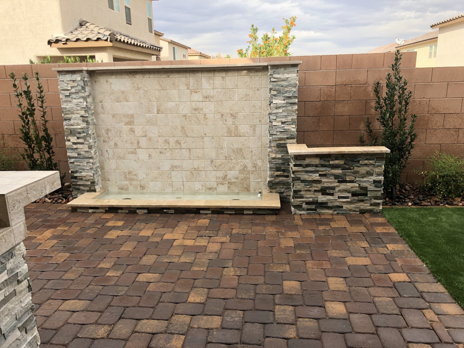 Finished paver patio with outdoor feature wall