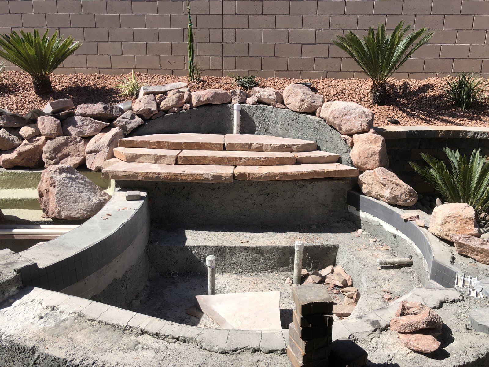 Stonework and steps during a backyard feature build